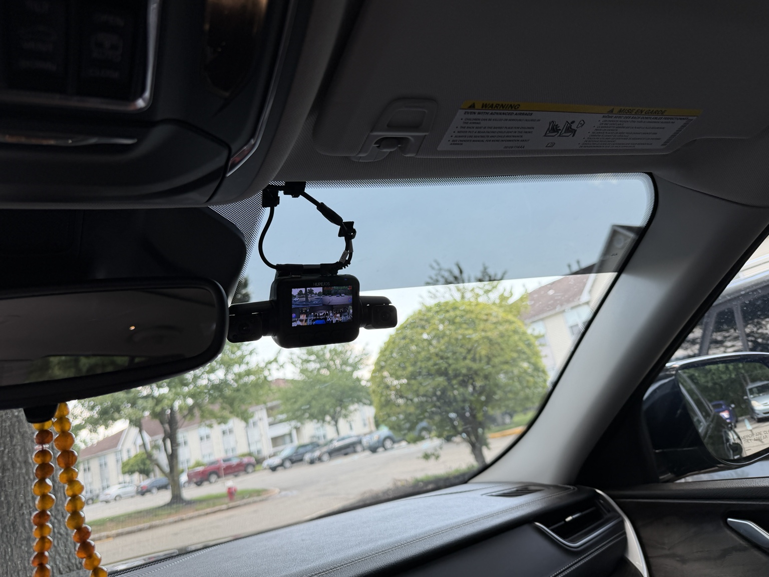 Front dash camera installed high on the windshield near the rearview mirror