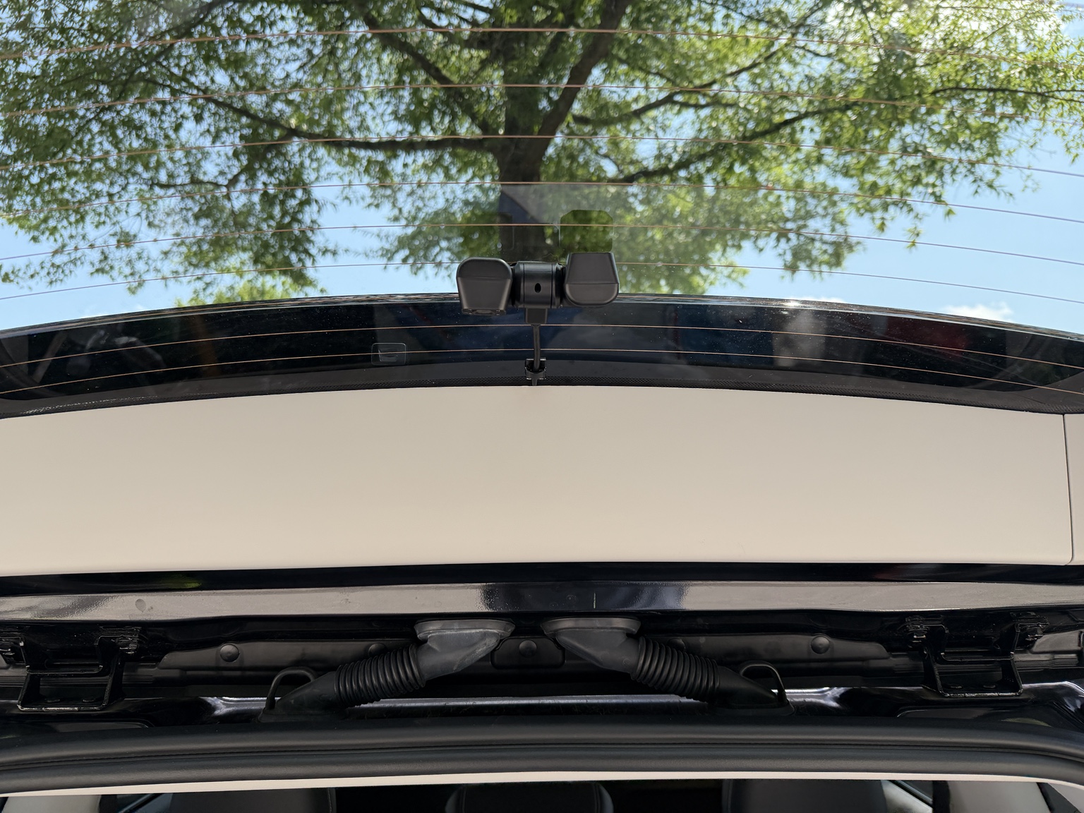 Rear dash camera cable routed through the vehicle factory hatch grommet